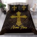 Black and gold Christian cross quilt blanket displayed across a modern bedroom bed