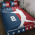 Baseball quilt blanket displayed on a bed with red, white, and blue batter artwork and star details