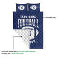 Navy football quilt blanket shown with a white quilted backing and printed front