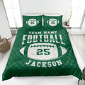 Green football quilt blanket displayed on a bed with matching football pillow designs