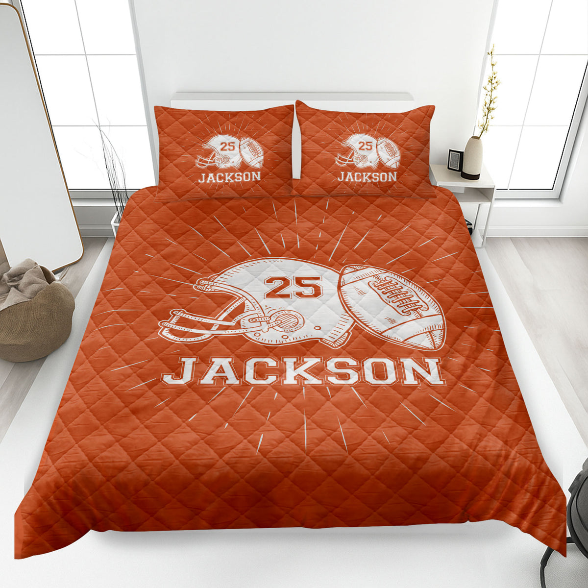 Orange football quilt blanket styled on a bedroom bed with helmet and football graphics