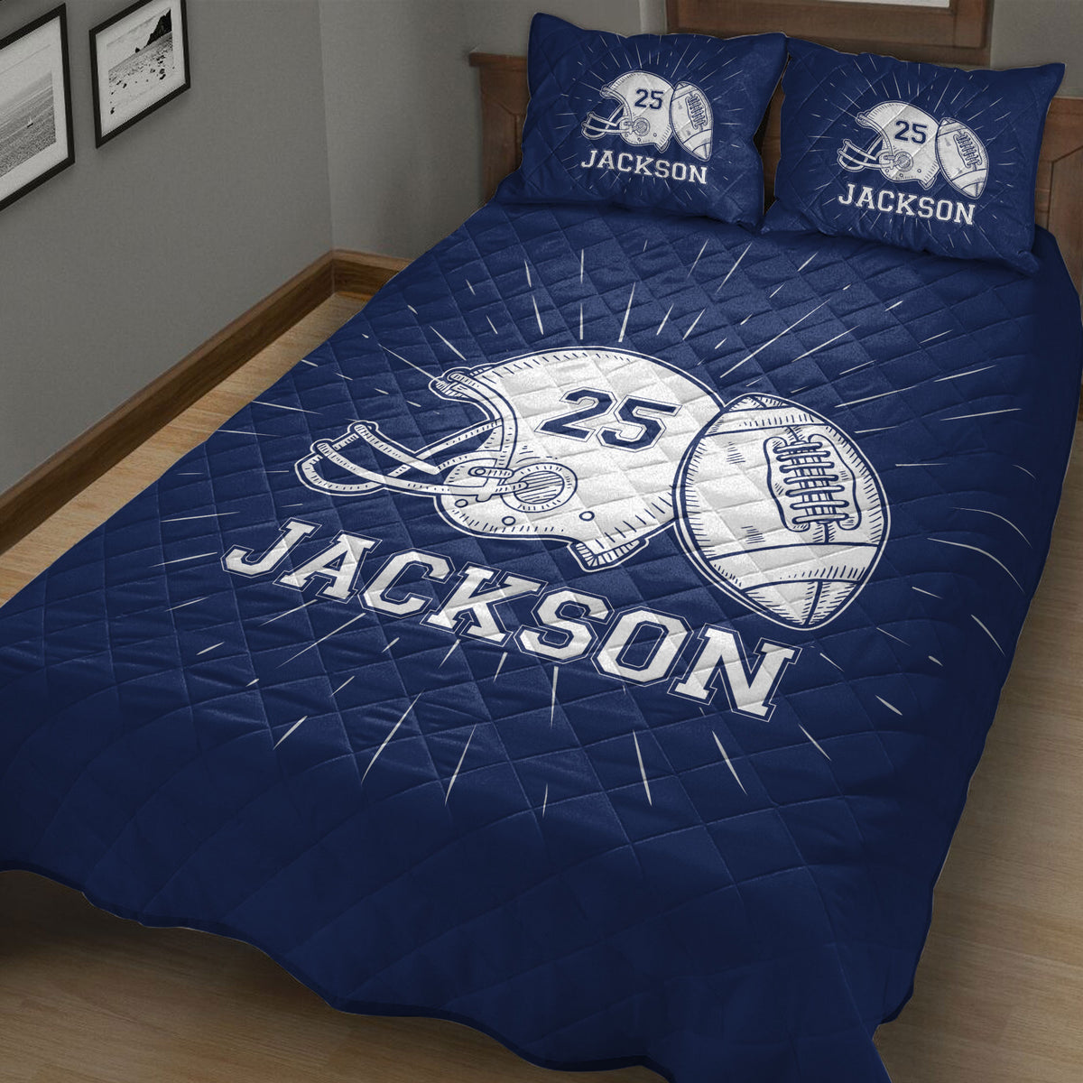 Close bedroom view of a navy football quilt blanket with helmet and football artwork