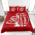 Red football quilt bedding displayed on a bed with strong sports artwork and quilted texture