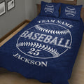 Navy baseball quilt blanket styled in a bedroom with oversized baseball graphics and bold lettering