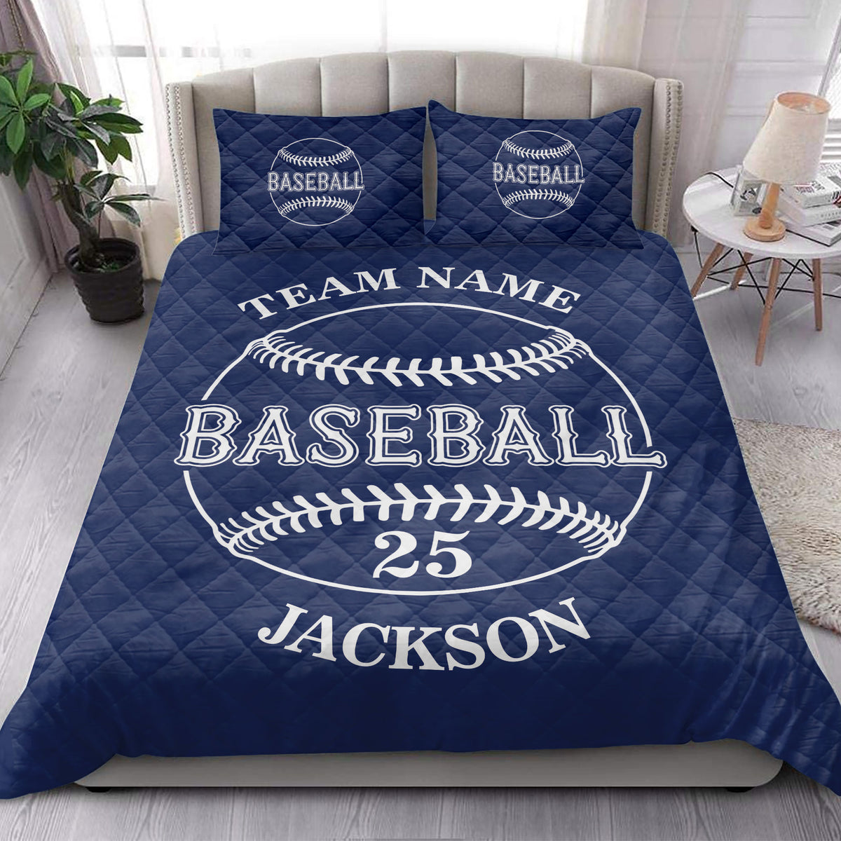 Navy baseball quilt blanket presented in a bright bedroom with baseball graphics and decorative pillows