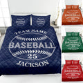 Navy baseball quilt blanket displayed on a bed with baseball artwork and coordinating pillow designs