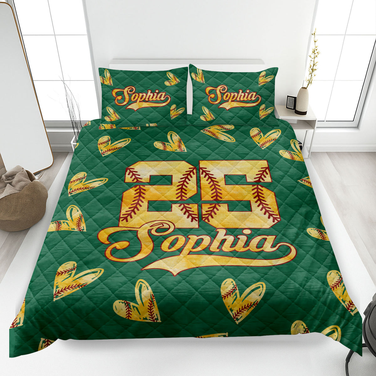 Green softball quilt blanket on a bedroom bed featuring golden stitched softball hearts and bold sports artwork
