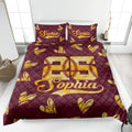 Maroon softball quilt blanket displayed on a bed with golden stitched softball hearts and sporty artwork
