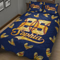 Close bedroom view of a navy softball quilt blanket with stitched softball hearts and large sports jersey artwork