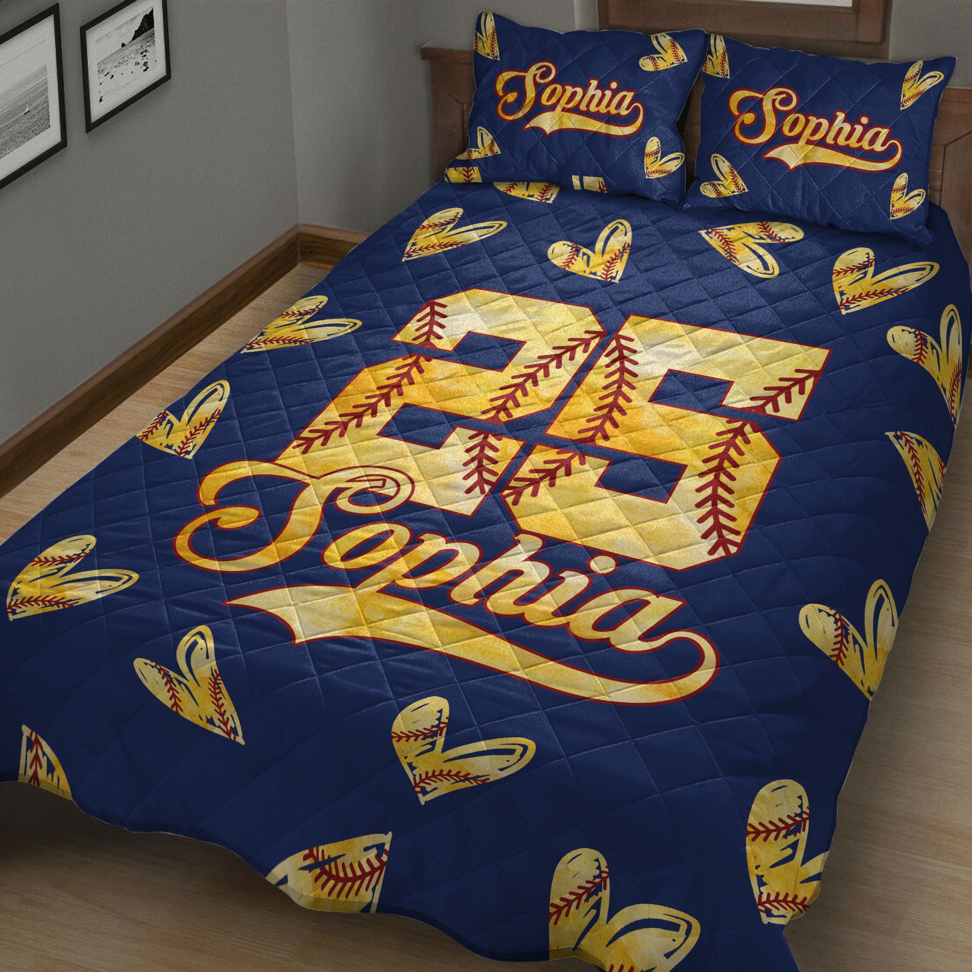 Close bedroom view of a navy softball quilt blanket with stitched softball hearts and large sports jersey artwork
