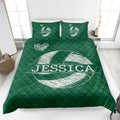 Green volleyball quilt blanket spread across a bedroom bed with bold white sports artwork