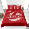 Red volleyball quilt blanket shown on a bed with heart details and prominent sports artwork