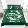 Green volleyball quilt blanket spread across a bed with bold white ball graphics and team-style design