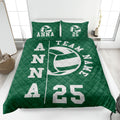 Green volleyball quilt blanket spread across a bedroom with a bold team-inspired ball design