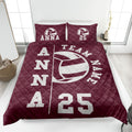 Maroon volleyball quilt blanket displayed on a bed with bold white sports artwork