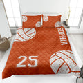 Orange volleyball quilt blanket displayed on a bed with distressed white volleyball graphics