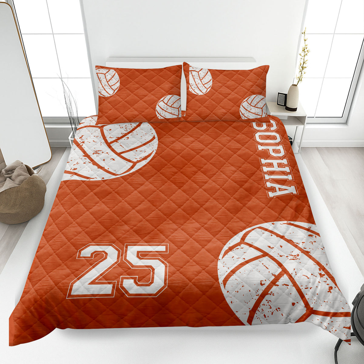 Orange volleyball quilt blanket displayed on a bed with distressed white volleyball graphics