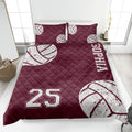 Maroon volleyball quilt blanket featuring white volleyball artwork and athletic bedroom styling