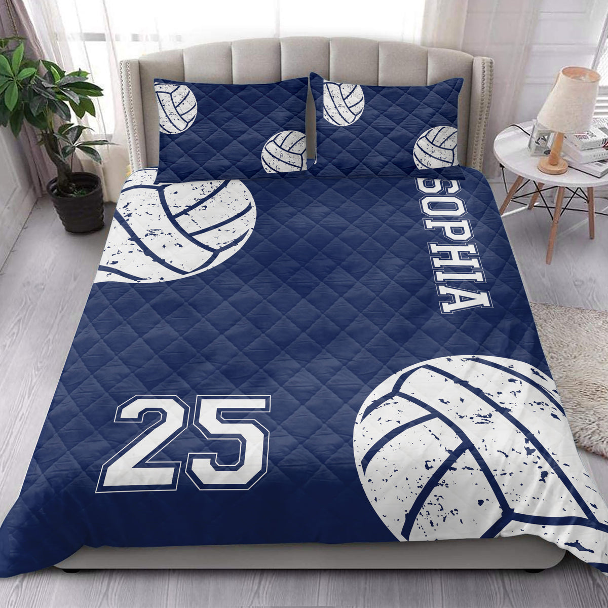 Navy volleyball quilt bedding set displayed in a bright bedroom with matching volleyball artwork