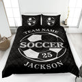 Black soccer quilt blanket featuring a bold white soccer ball design on a neatly made bed