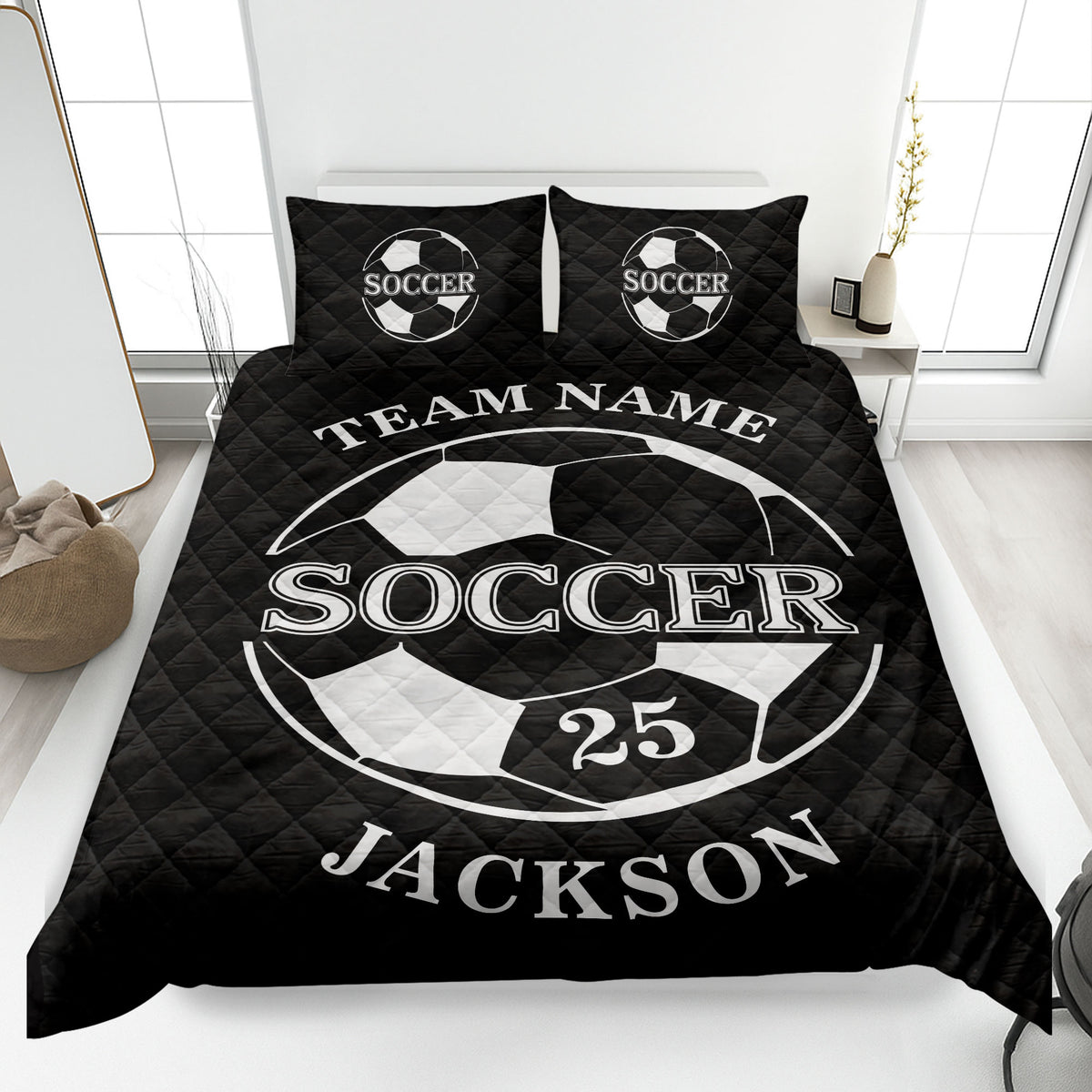 Black soccer quilt blanket featuring a bold white soccer ball design on a neatly made bed
