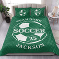 Green soccer quilt blanket shown in a bright bedroom with soccer ball graphics and coordinated bedding