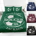 Green soccer quilt blanket displayed on a bed with soccer ball artwork and coordinated sports bedding