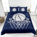 Navy basketball quilt blanket displayed on a bedroom bed with white basketball graphics