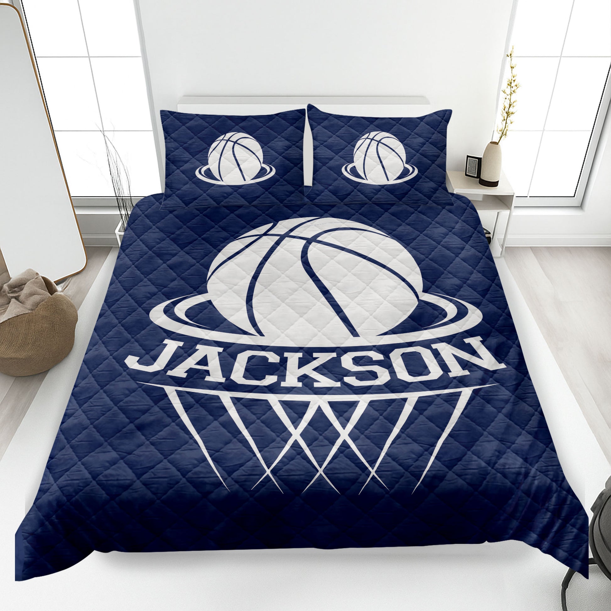 Navy basketball quilt blanket displayed on a bedroom bed with white basketball graphics