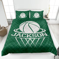 Green basketball quilt blanket styled in a bedroom with bold white basketball artwork