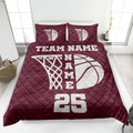 Maroon basketball quilt blanket featuring a large white hoop and basketball design on a bedroom bed