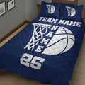 Close bedroom view of a navy basketball quilt blanket with large hoop and basketball graphics