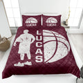 Maroon basketball quilt blanket with an active player silhouette, oversized basketball graphic, and quilted texture