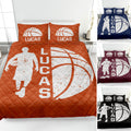 Orange basketball quilt blanket styled on a bed with player silhouette, basketball artwork, and printed pillow designs