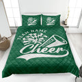 Green cheerleading quilt blanket spread across a bed with pom-pom and megaphone artwork