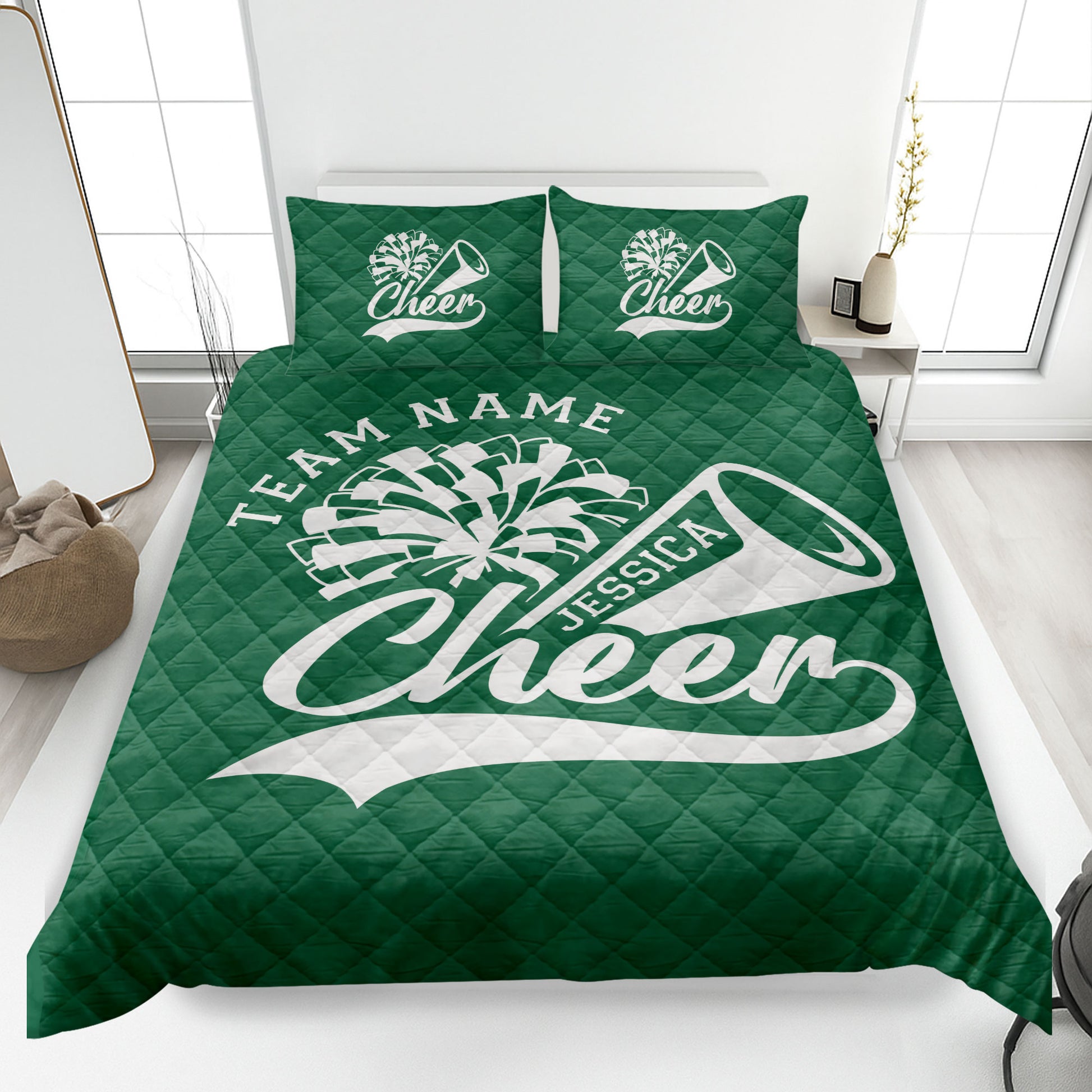 Green cheerleading quilt blanket spread across a bed with pom-pom and megaphone artwork
