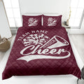 Maroon cheerleading quilt blanket displayed on a bed with energetic cheer graphics