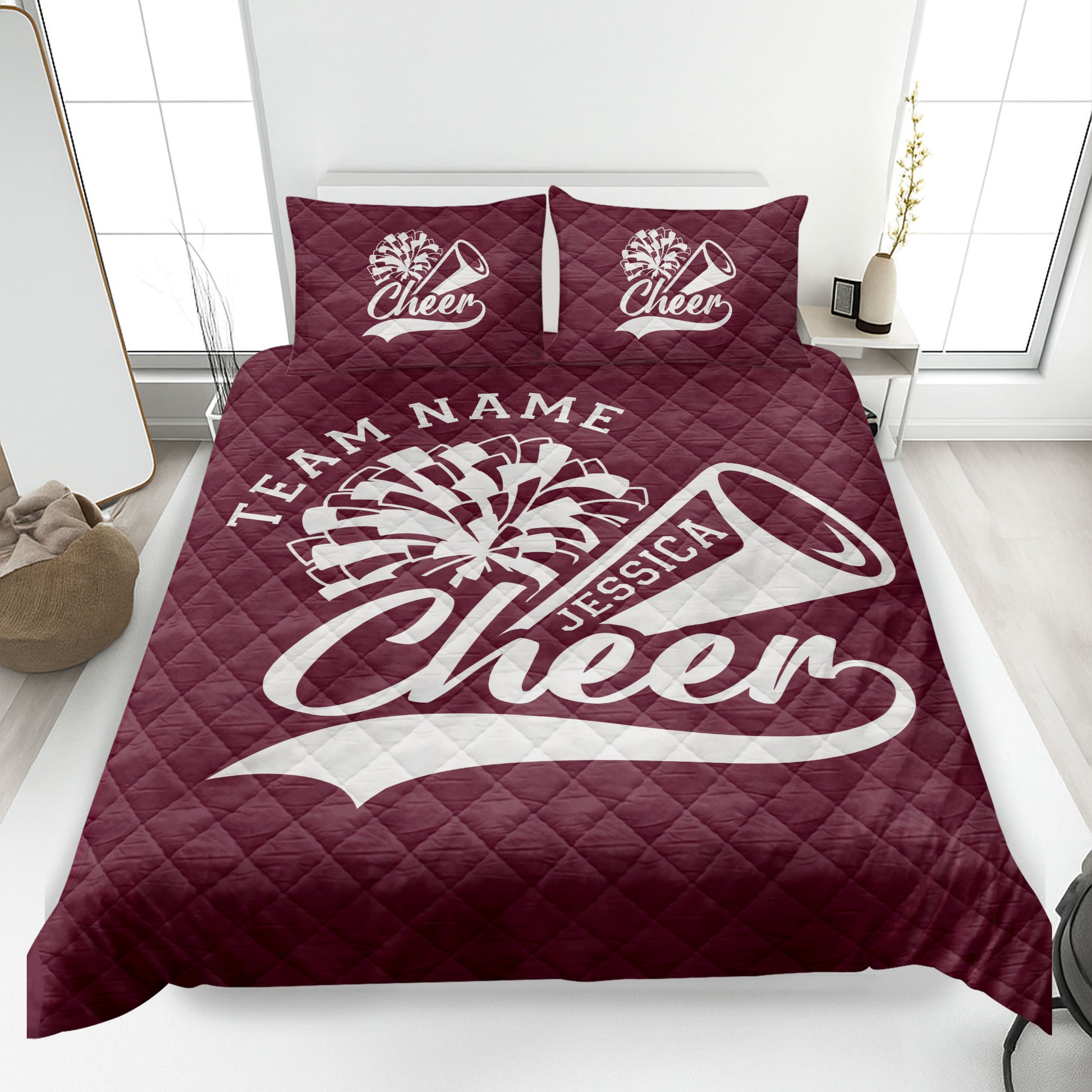 Maroon cheerleading quilt blanket displayed on a bed with energetic cheer graphics