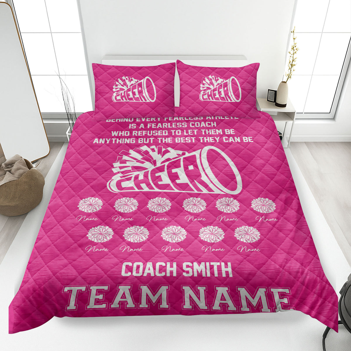 Bright pink cheerleading quilt blanket with white megaphone and pom-pom design in a bedroom
