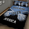 Blue cheerleading quilt blanket shown in a bedroom with pom-pom graphics and coordinated pillow artwork
