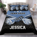 Blue cheerleading quilt blanket styled in a bright bedroom with star accents and large pom-pom artwork