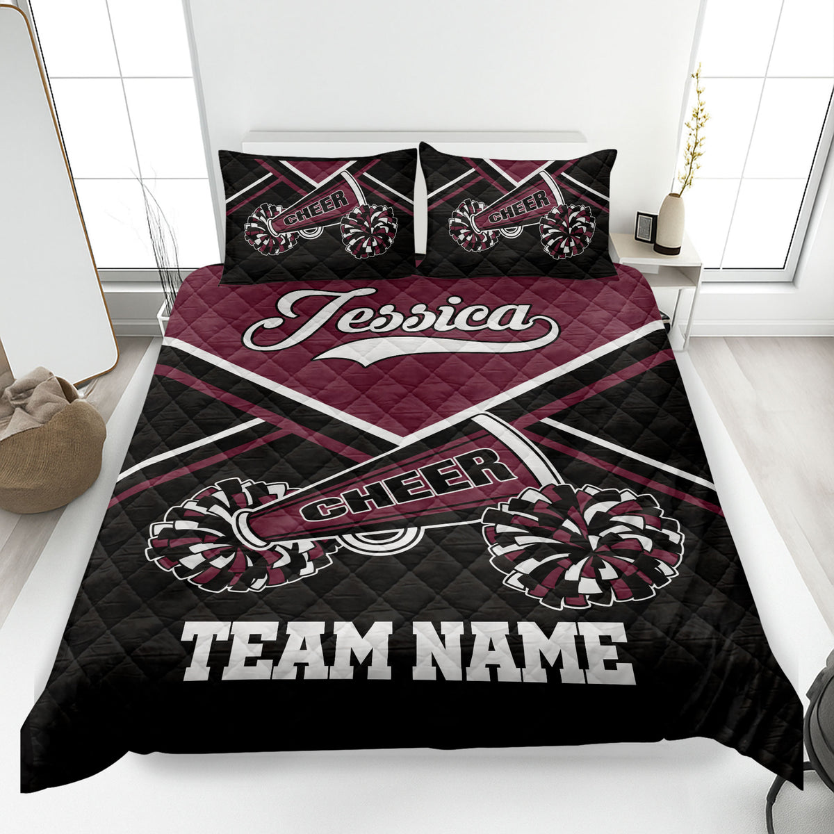 Maroon and black cheerleading quilt blanket with pom-pom artwork in a bedroom setting