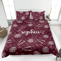 Maroon cheerleading quilt blanket featuring white pom-poms, megaphones, stars, and lightning details