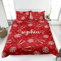Red cheerleading quilt blanket styled on a bed with pom-poms, megaphones, stars, and lightning motifs
