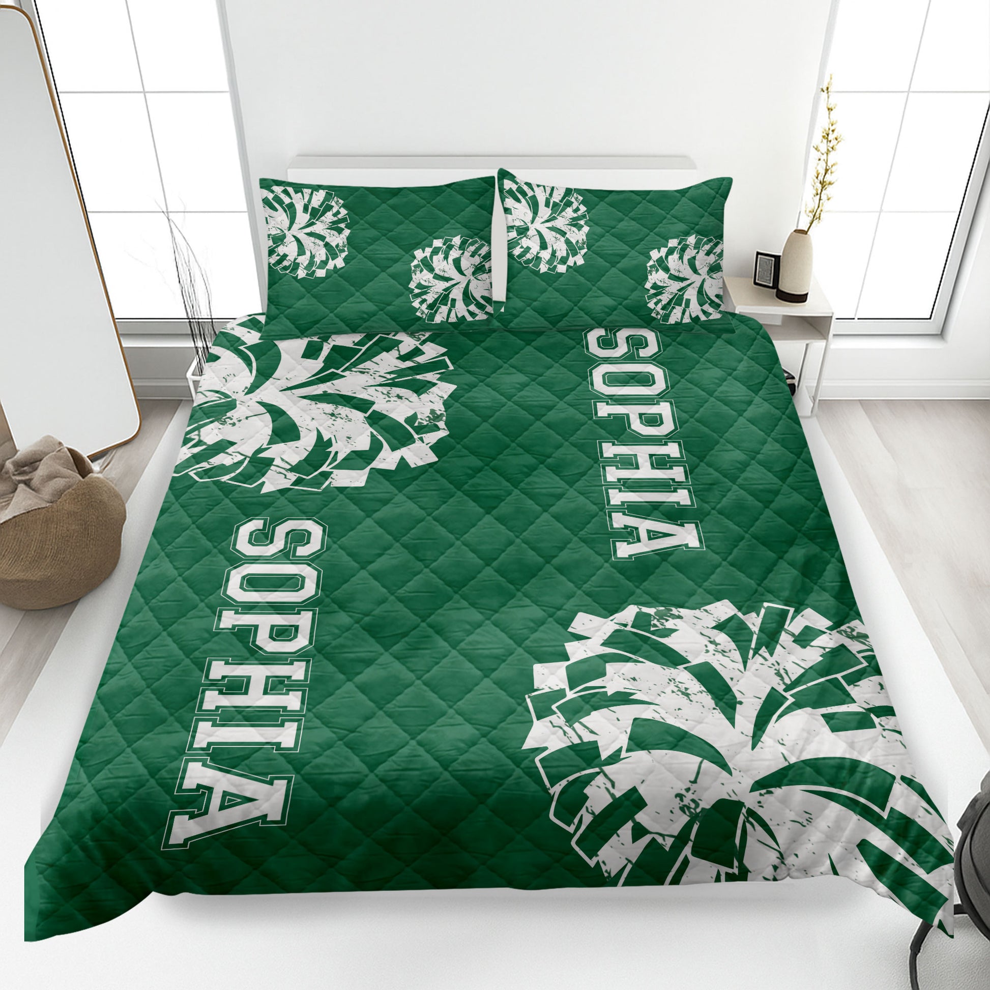Green cheerleading quilt blanket styled on a bedroom bed with bold pom-pom graphics