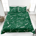 Green hockey quilt blanket featuring crossed hockey sticks and puck artwork across the bed