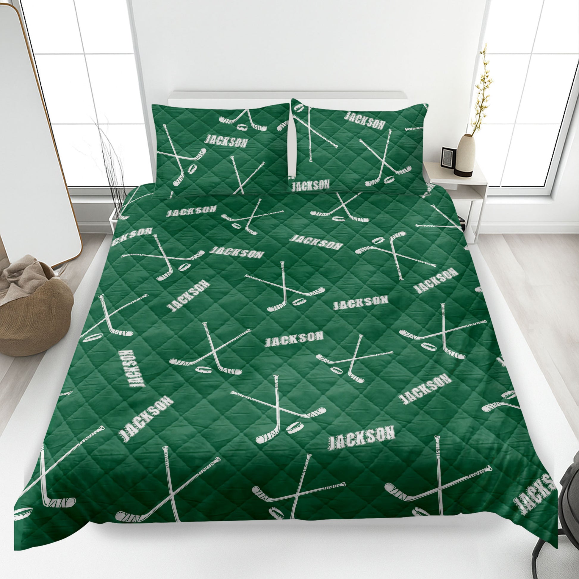 Green hockey quilt blanket featuring crossed hockey sticks and puck artwork across the bed