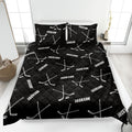 Black hockey quilt blanket with white hockey sticks and pucks in a bold bedroom design