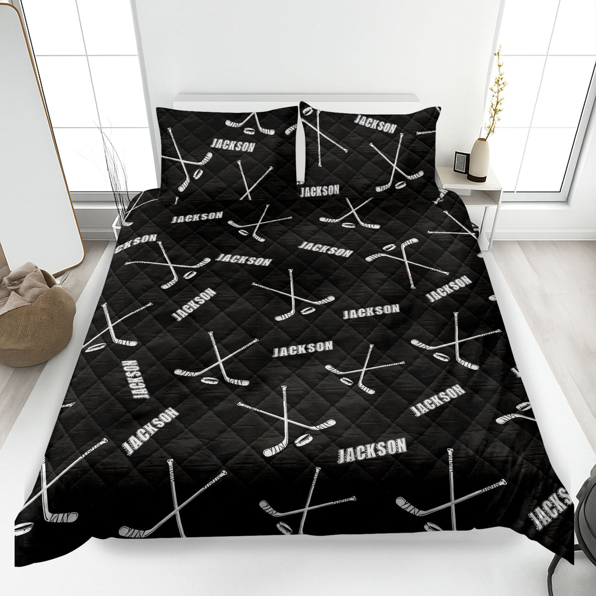 Black hockey quilt blanket with white hockey sticks and pucks in a bold bedroom design