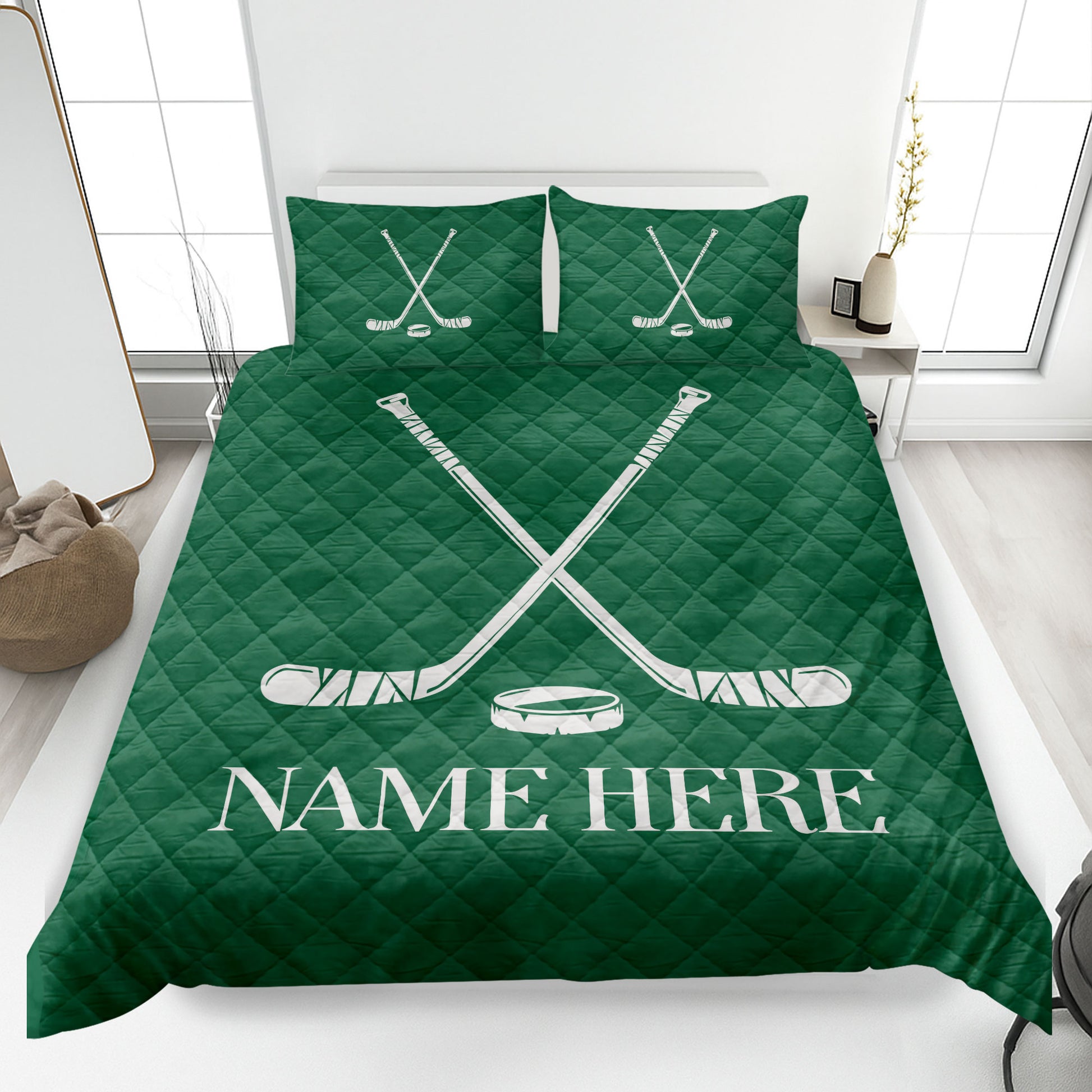 Green hockey quilt blanket on a bed featuring crossed hockey sticks and puck artwork